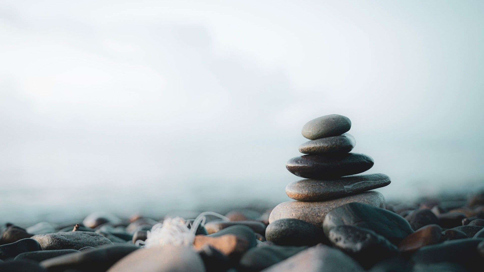 Pebbles arranged on top of each other. It represents the peace after a cacao immersion with Oona